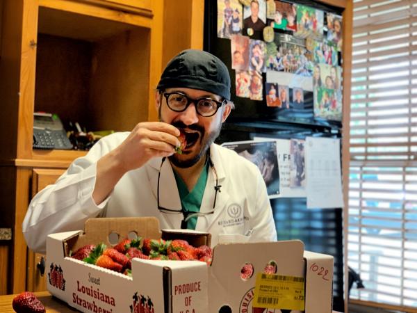 Dr. Akin Enjoying Fresh Louisiana Strawberries 